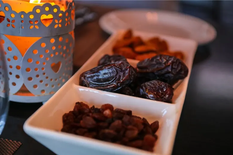 Close-up of fresh dates, raisins, and dried fruit served in a dish, representing local produce from Ras Al Khaimah’s date farms and markets.