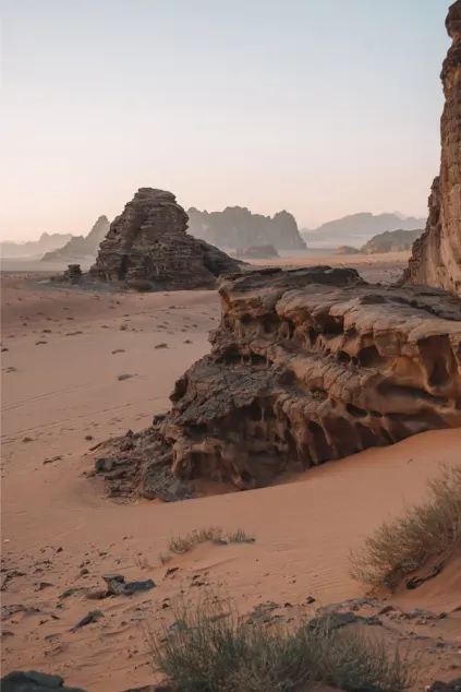 Scenic view of rocky formations and sandy terrain in Ras Al Khaimah’s desert, showcasing natural landscapes often explored during wadi adventures.