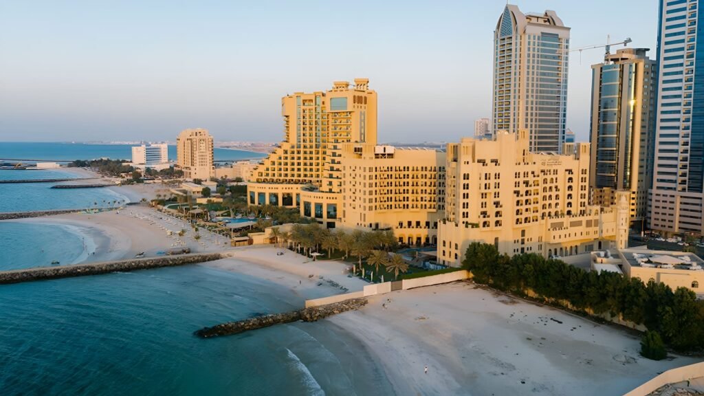 Aerial view of luxury seaside resorts in Ajman with golden sandy beaches and turquoise waters along the Arabian Gulf coastline