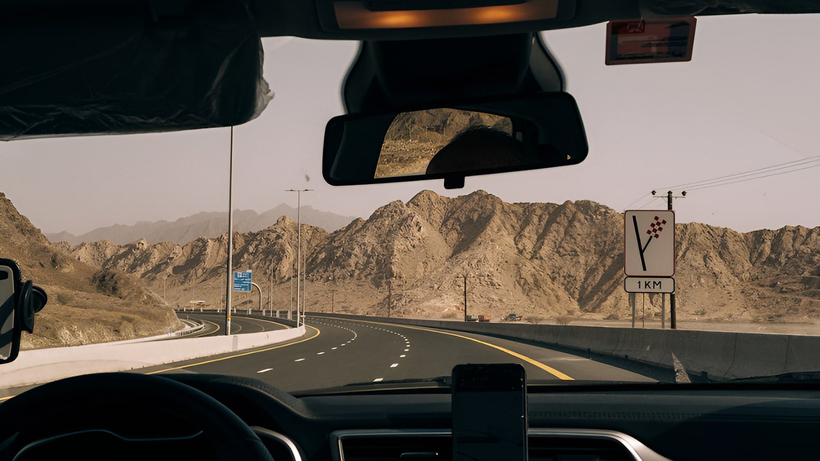 Driving through Fujairah’s Hajar Mountains with scenic desert and rocky peaks 