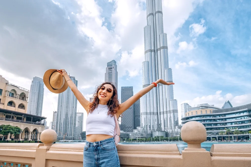 Happy Female Tourist with Burj Khalifa View in the background